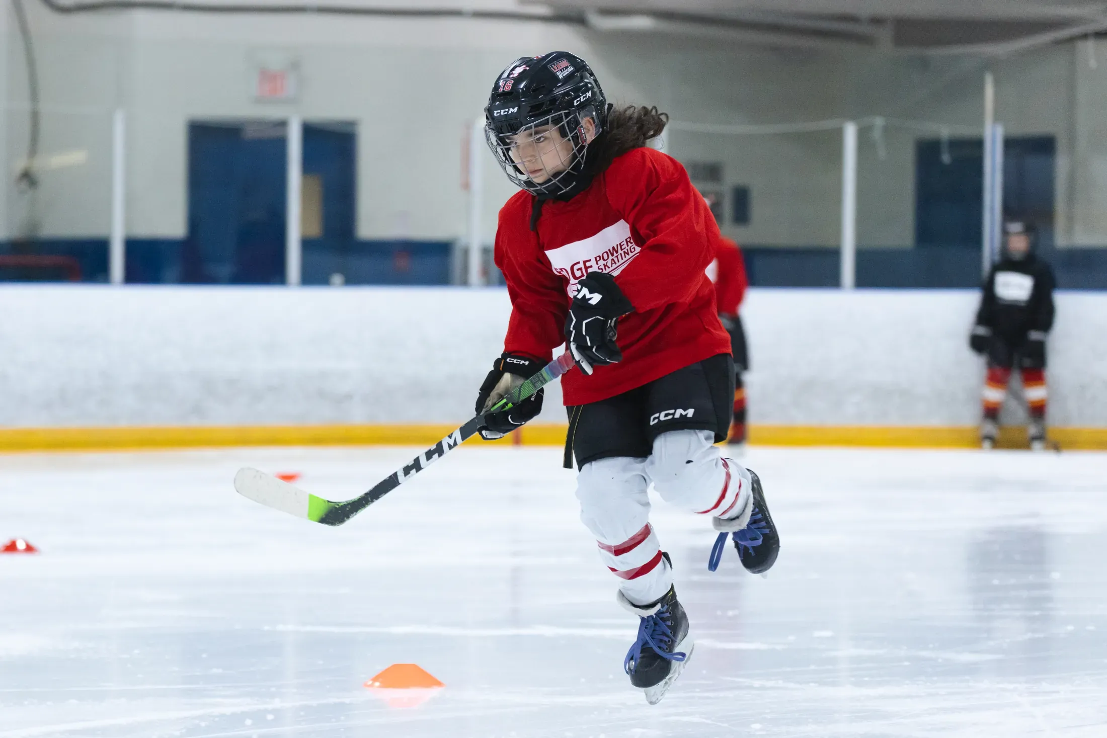 An Edge player driving a powerful forward stride at game tempo
